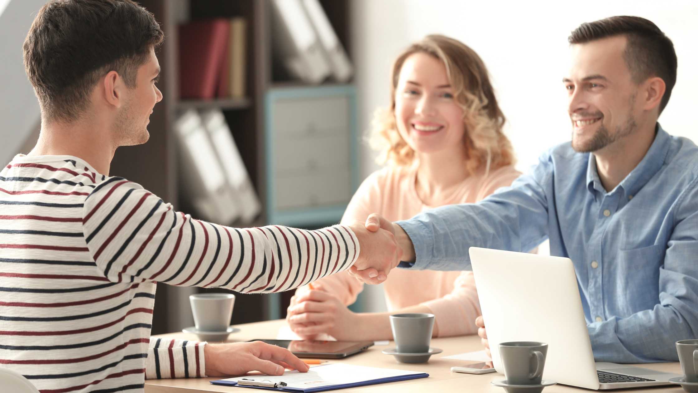 Teen shakes hands with a counselor during a motivational interviewing session at Nexus Teen Academy, fostering trust, confidence, and personal growth.