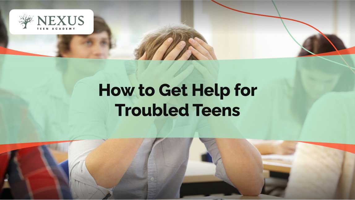 “Distraught teenage boy sits in classroom with head in hands as peers work, titled ‘How to Get Help for Troubled Teens.’”