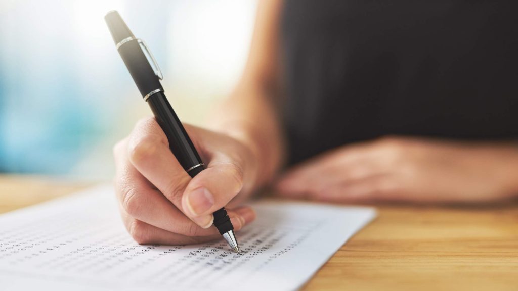 Close-up of a person filling out a multiple-choice test, representing an ADHD assessment process for teens.