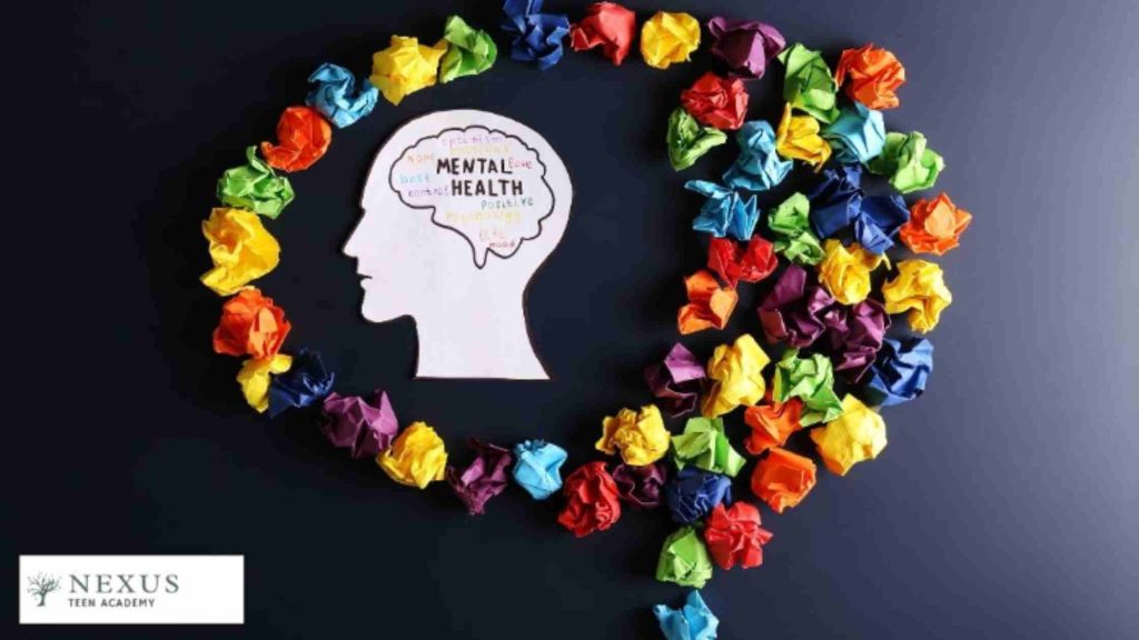 A paper head with brain words surrounded by colorful paper balls, symbolizing teen mental health and suicide risk.