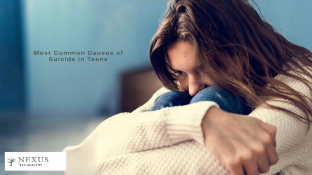 A sad teen sitting alone, reflecting emotional distress and the underlying causes of suicide in teenagers.