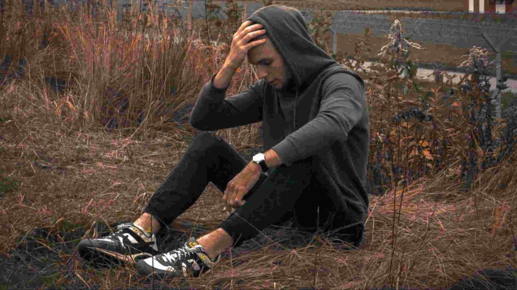 Teen boy sitting alone, distressed and overwhelmed, reflecting a son threatened to run away and signaling emotional crisis.