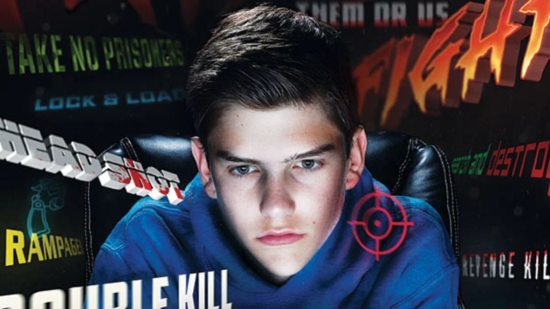 Teen focused intensely on violent style game screen showing how game design and content can heighten emotional arousal.