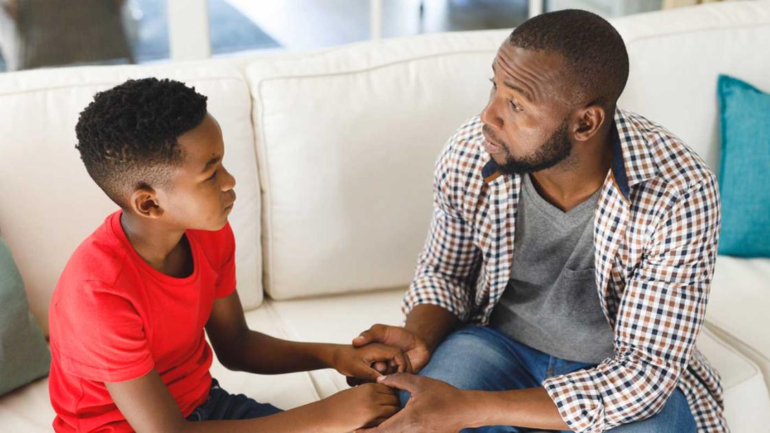 Father talking with his son, showing how parents can help teen boys facing cannabis use, anxiety, and behavioral changes.