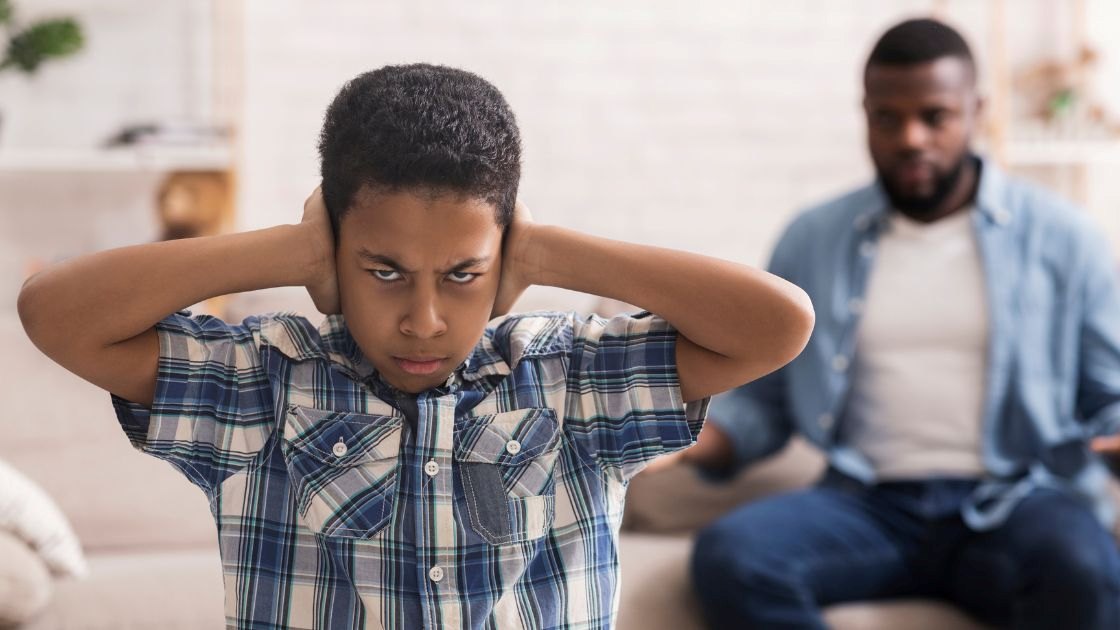 A frustrated teen covering their ears while their parent wonders how they should respond to the anger that is depression.