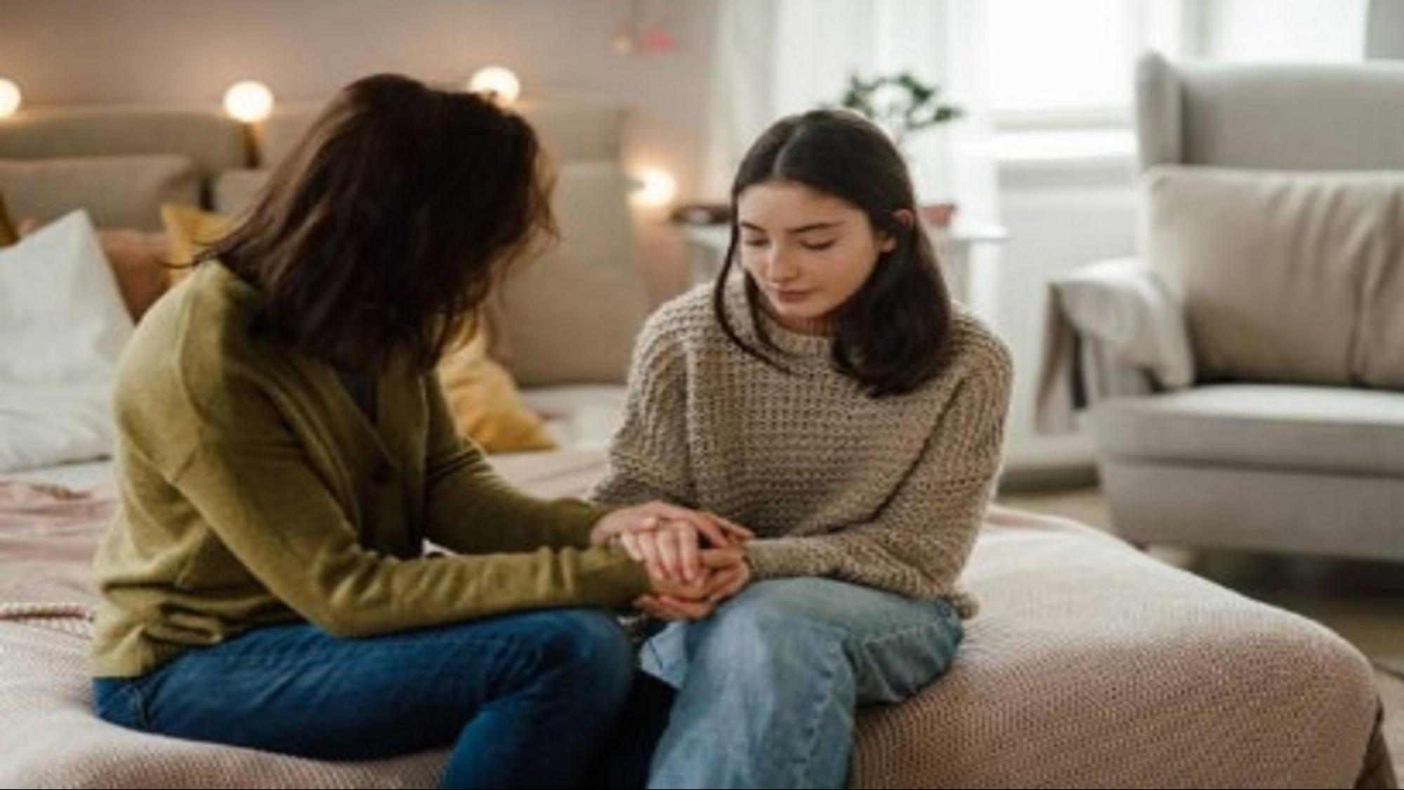 Parent gently holding teen hands during calm conversation, showing how to talk to a teen who says I don’t feel anything.