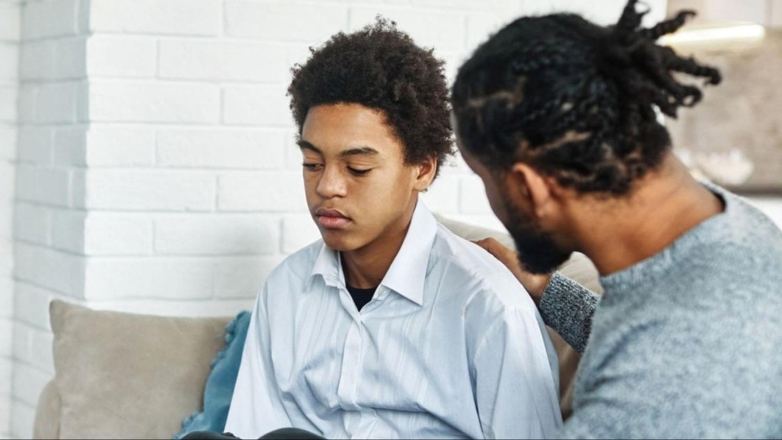 Parent supporting a withdrawn teen during a calm conversation that builds trust and encourages honest communication.
