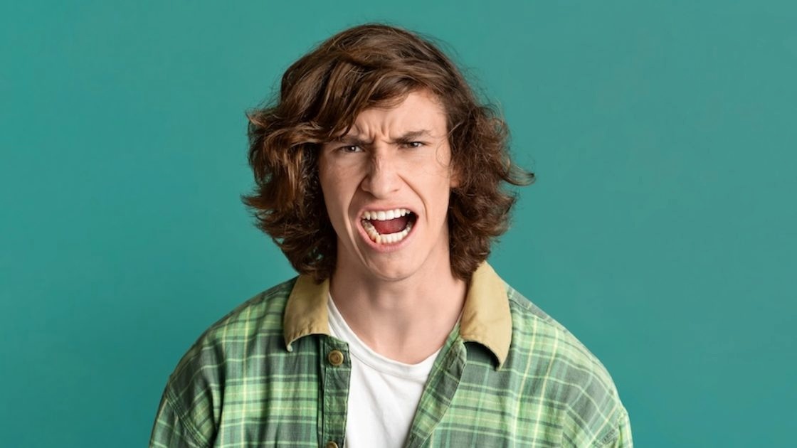 Teen boy yelling with visible frustration, reflecting irritability and emotional overload linked to teen depression.