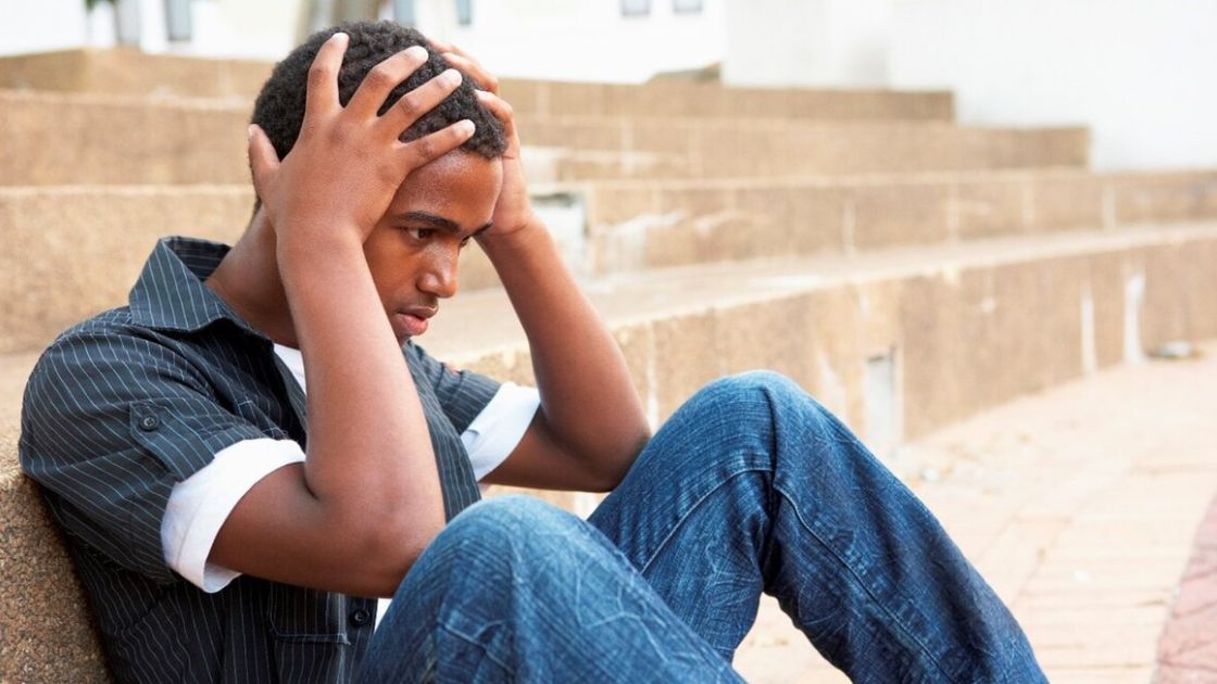 Teen boy overwhelmed and isolated, symbolizing hidden Pure-O intrusive thoughts and silent OCD distress parents may miss.