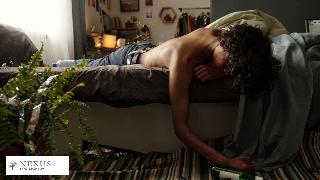 Teen passed out on bed with an alcohol bottle; illustrates warning signs your teen might be using alcohol and marijuana.