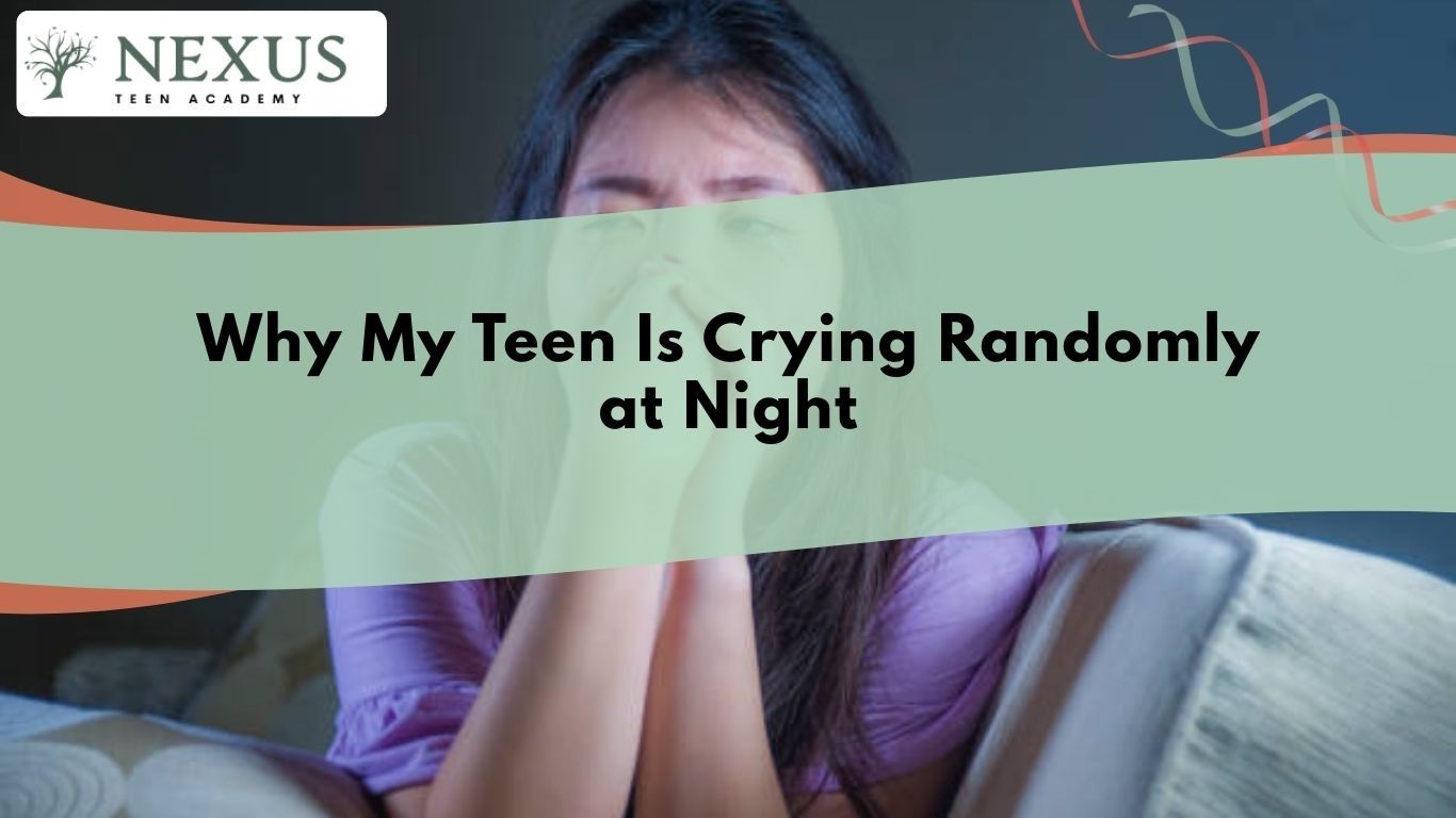 Teen girl crying alone at night while sitting on couch, illustrating emotional distress and reasons why teens cry randomly at night