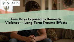 teen-boys-domestic-violence-trauma-effects – Teen Mental Health Treatment in Arizona – Teen Mental Health Treatment in Arizona Nexus Teen Academy title card for Teen Boys Exposed to Domestic Violence, Long-Term Trauma Effects, showing a teen boy sitting alone on a couch